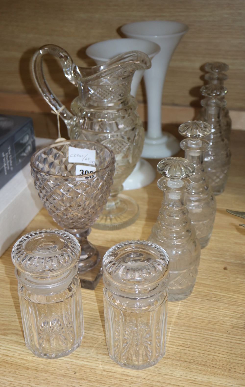 A quantity of 19th century cut glass including a set of four small decanters, together with a pair of opaque white glass vases